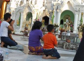 Family worshiping at a Buddhist Temple